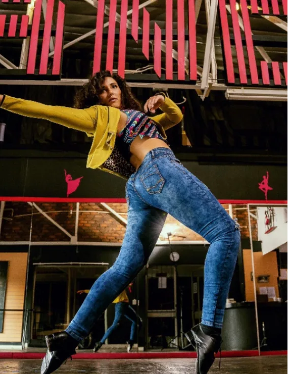 Nadia Katz performing an expressive dance movement in a studio