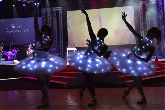 Illuminated dancers performing Nadia's stage choreography