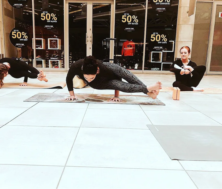 Nadia Katz demonstrating a dramatic yoga arm balance