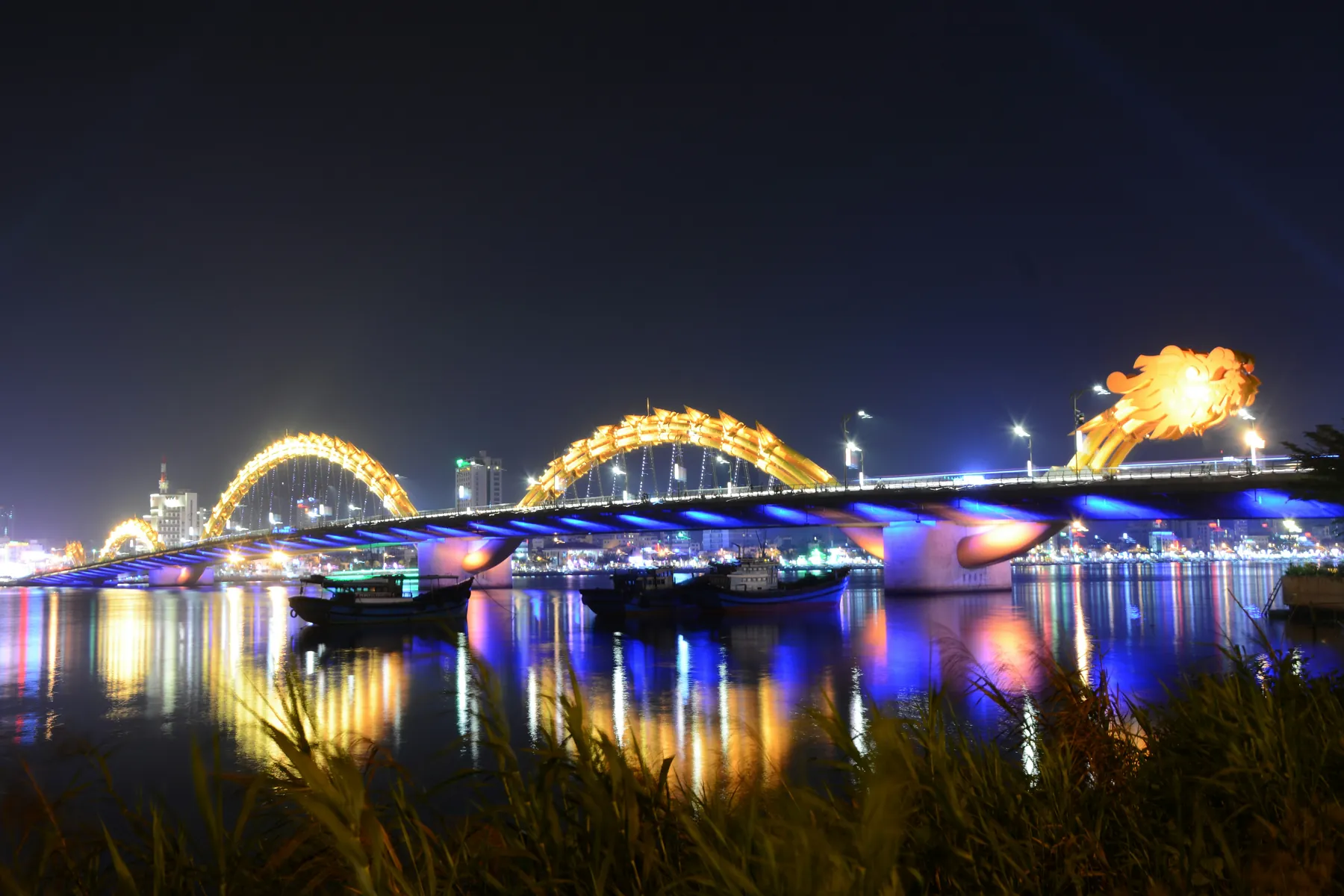 Dragon Bridge illuminated over the Han River in Da Nang, Vietnam